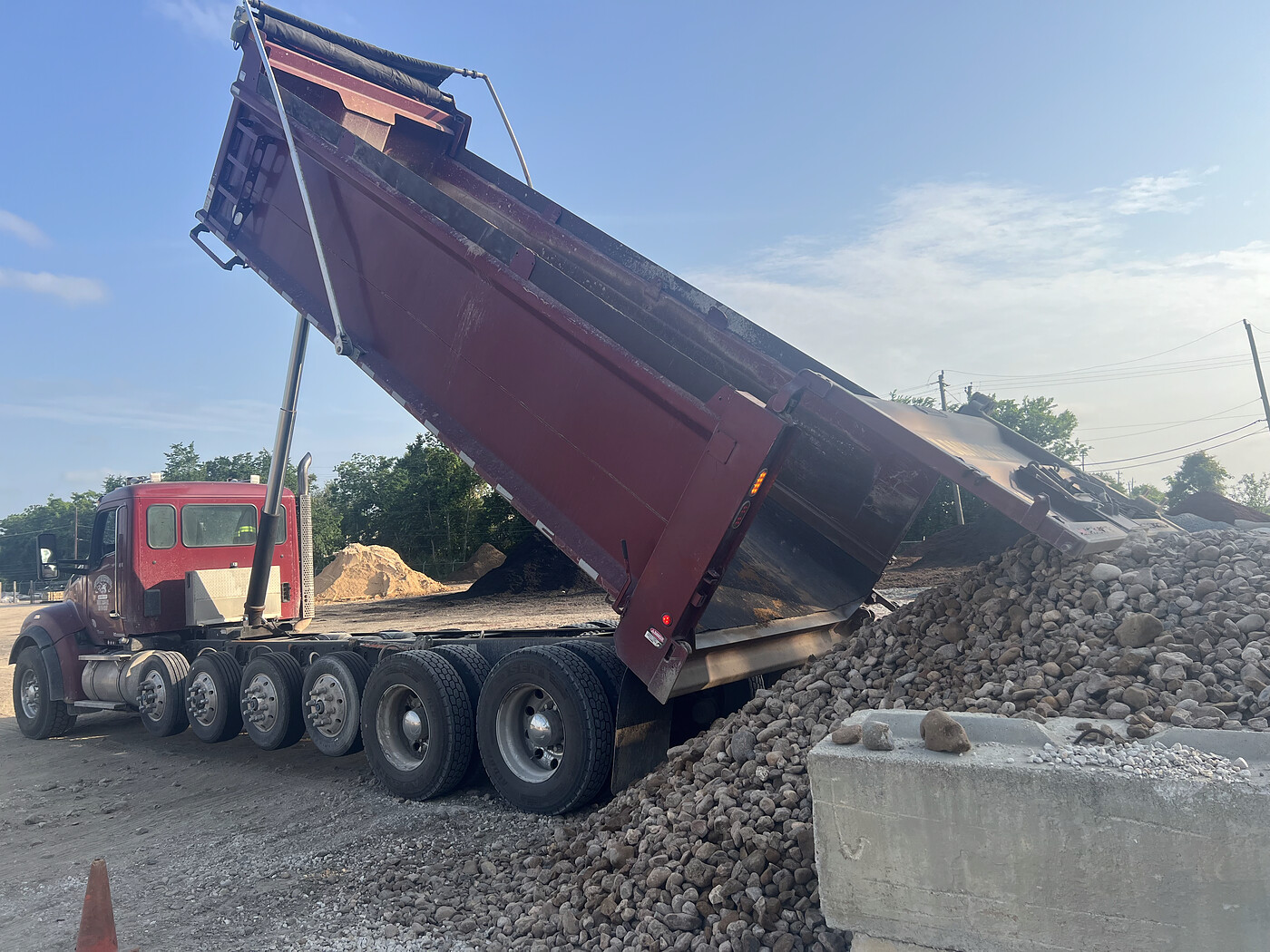 Dump truck dumping a load of gravel at a Houston job site