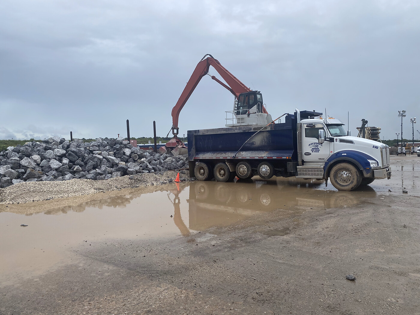 Dump truck delivering aggregate to a Houston construction site